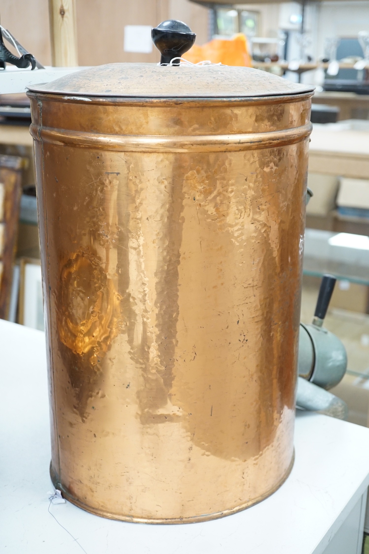 A copper coffee bean dispenser. 60cm high